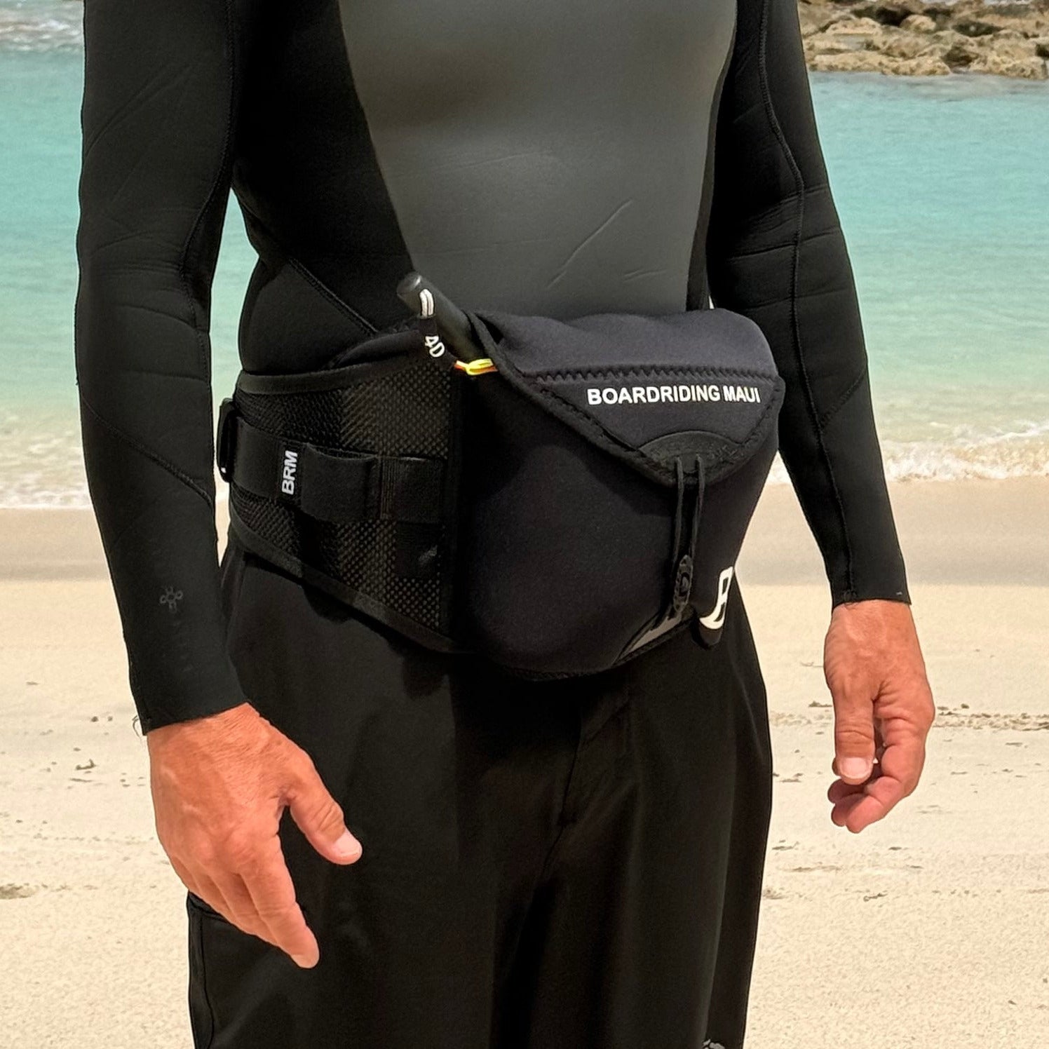 Person wearing a wetsuit and a parawing stash belt