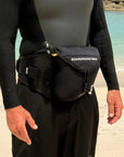 Person wearing a wetsuit and a parawing stash belt