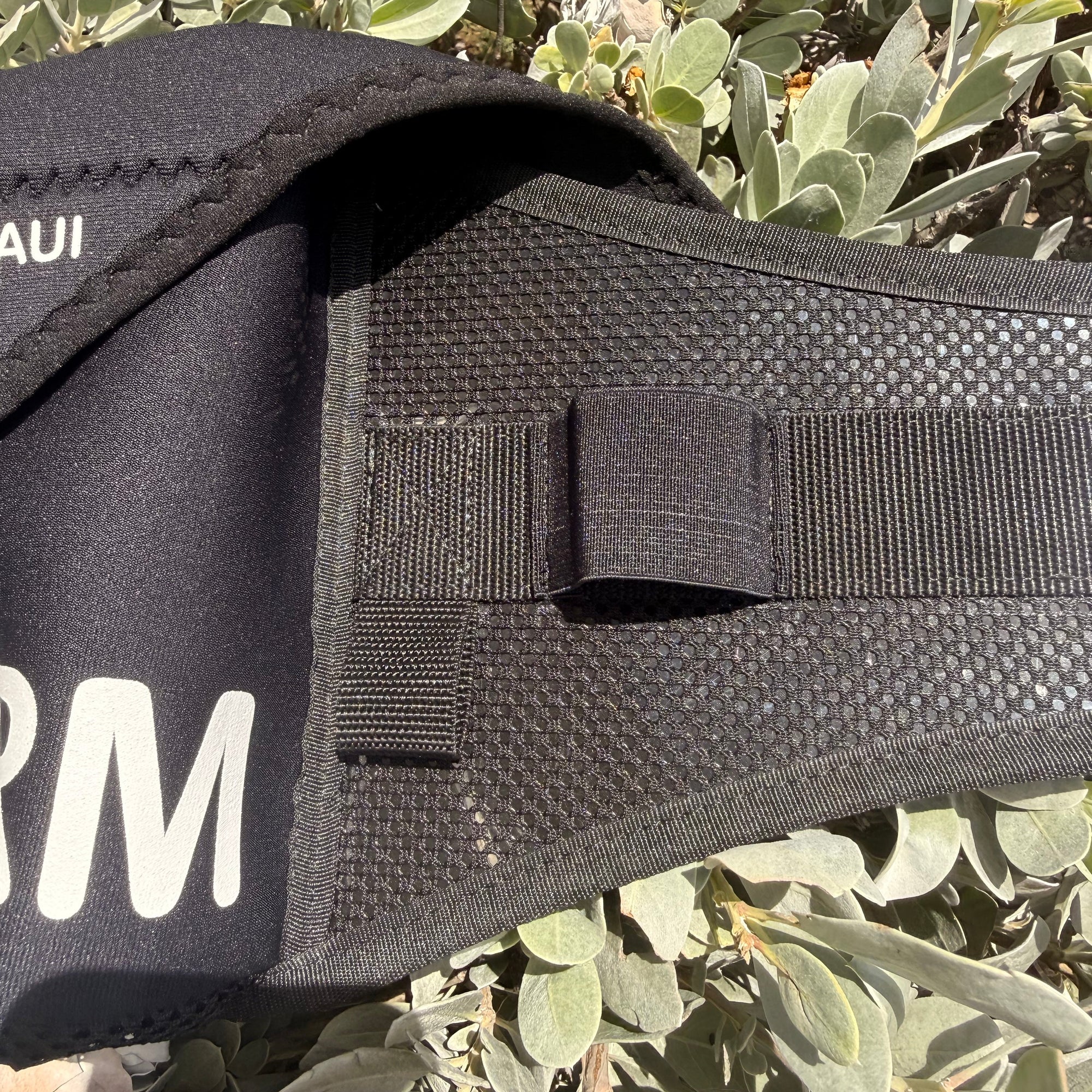 Black bag with 'BRM' branding on a green leafy background